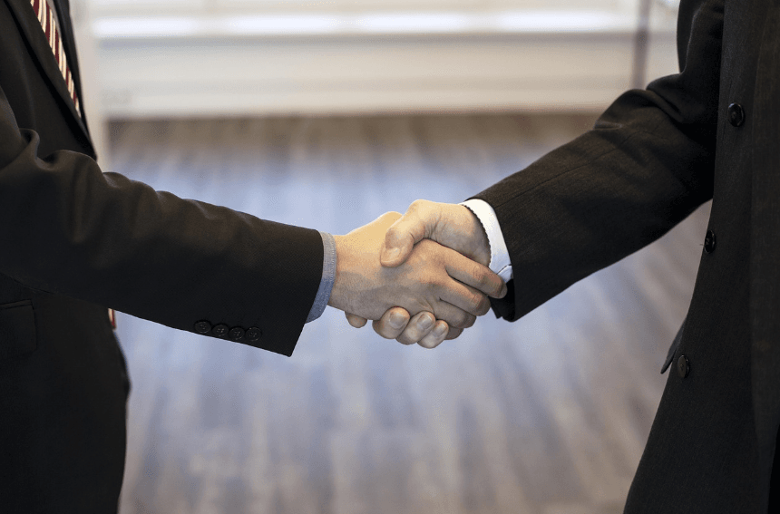 A trusted Seoul private guide (Colin, JS Network Member) shaking hands with a client, symbolizing trust and professional service.